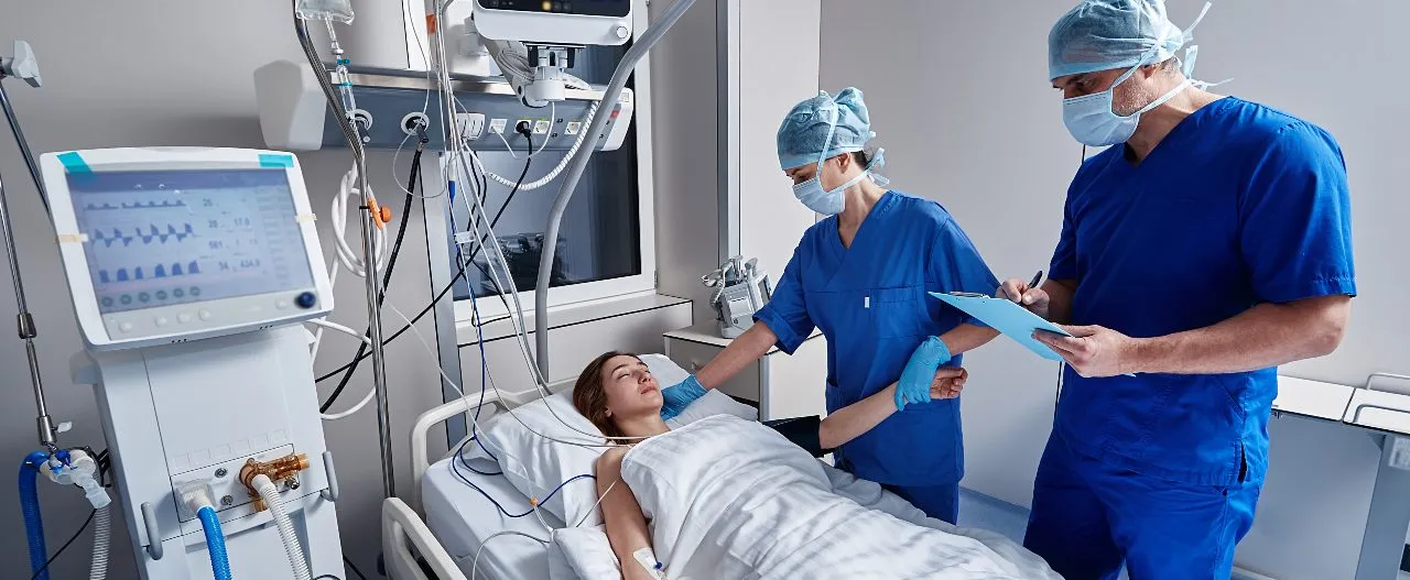 ICU nurses working near the patient's bedside
